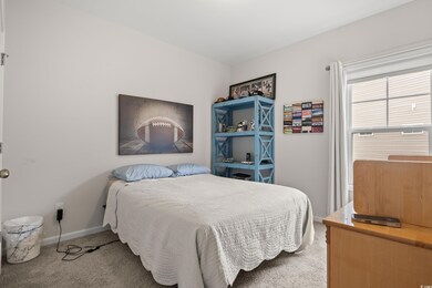 Bedroom with carpet floors and baseboards