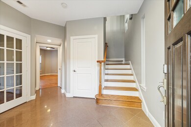 First floor: The spacious foyer leads to the two d