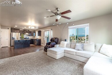 Living room featuring a chandelier, a ceiling fan, dark wood finished floors, and recessed lighting