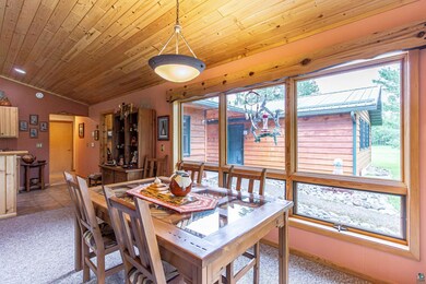 Carpeted dining room with wooden ceiling, plenty o