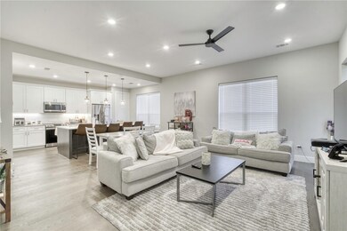 Living room with baseboards, visible vents, a ceil