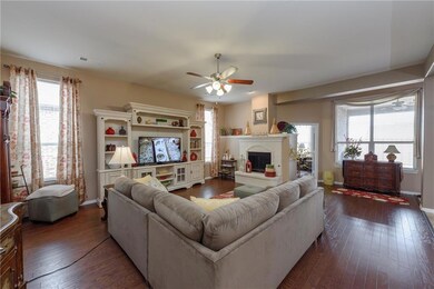 Elegant living area with wood floors and pretty fi