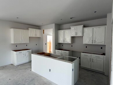 Kitchen featuring a kitchen island, concrete floor