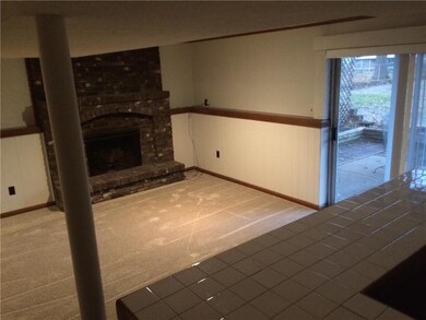 Lower level family room with fireplace and bar, walk out to back yard.