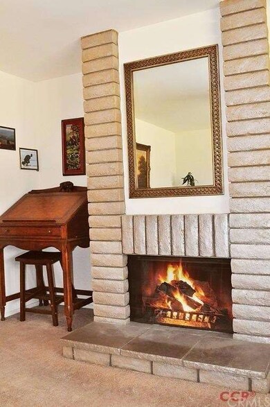 Gas fireplace in living room with a desk nook