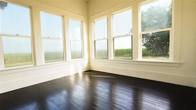 Unfurnished sunroom with wood-type flooring