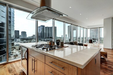 Sleek and Elegant Island Kitchen featuring Marble Counters, Miele Appliances, Wine cooler and lots of storage space.