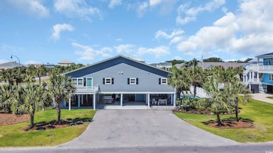 Coastal inspired home with a  driveway, and side lawn