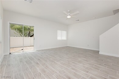 Unfurnished room featuring a ceiling fan and light