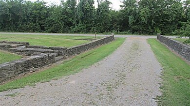 Attractive entrance with stone walls on each side.