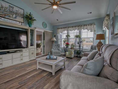 Living room featuring ceiling fan, dark wood-type 