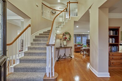 Two Story entry way as you walk in, gleaming wood floors throughout and neutral colors.