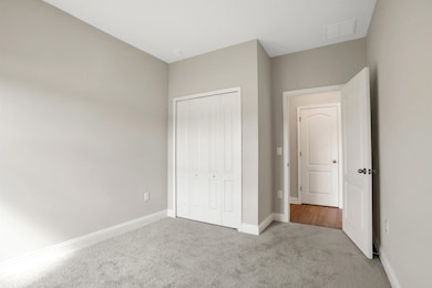 Unfurnished bedroom featuring carpet and a closet