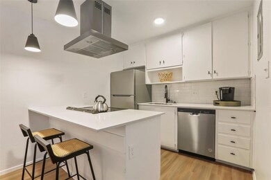 Kitchen featuring island exhaust hood, stainless 