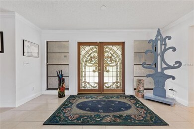 Double leaded glass doors lead into the spacious f