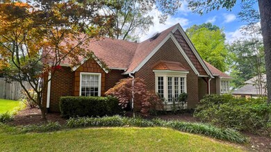 Tudor home with a front yard
