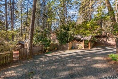 Front of home from parking area and round about.