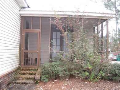 Relax on the screened porch with brick flooring