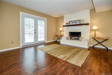 Den with wood burning fireplace