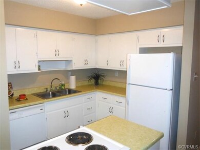 Kitchen with island cooktop, eat-in area, and laun