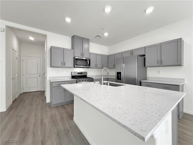 Kitchen featuring light stone counters, visible ve