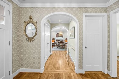 Arched passageway with large coat closet - refinis