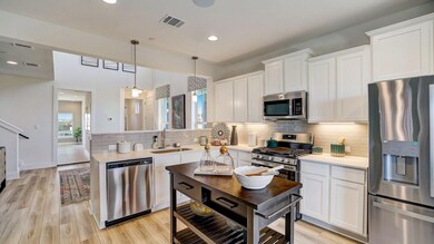 Kitchen with stainless steel appliances, a sink, 