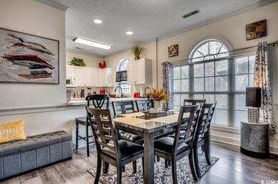 Dining area with ornamental molding, sink, a textu