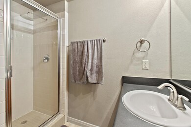 Full bathroom featuring a sink and a shower stall