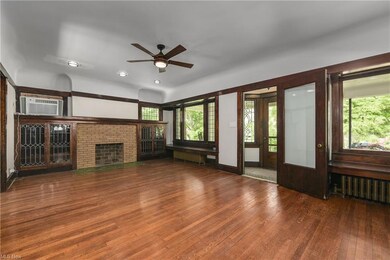 Another view of the living room facing the front door vestibule and fireplace.