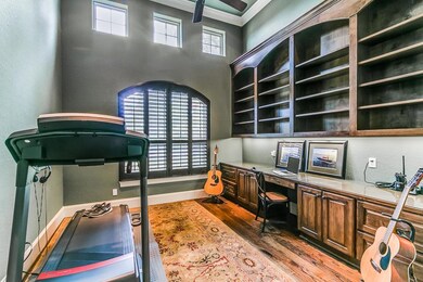 Set behind French doors is the private study with wood floors, custom built-ins & plantation shutters.