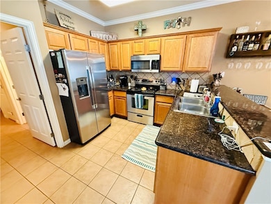 Kitchen featuring light tile patterned floors, tas