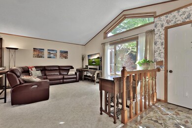 Living room with full wall to ceiling windows for an abundance of natural light.