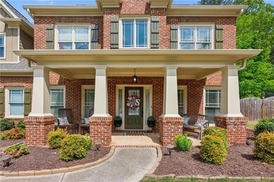 Property entrance featuring fence, covered porch, 