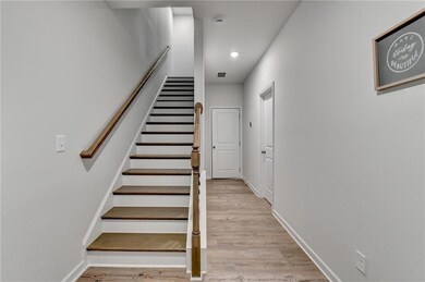 Stairway with recessed lighting, wood finished flo