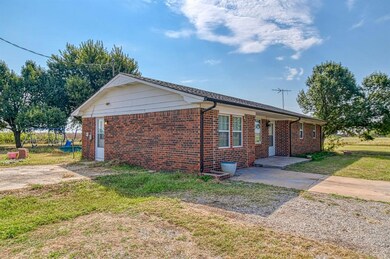View of front facade with brick siding and a front yard
