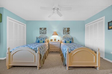 Bedroom with light colored carpet, ceiling fan, an