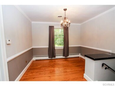 Formal dining room with crown moulding, hardwood f