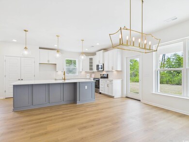 Kitchen featuring appliances with stainless steel finishes, light wood-style floors, white cabinetry, recessed lighting, and light countertops
