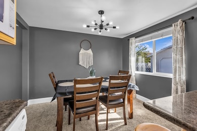 Dining area featuring a chandelier and light colored carpet