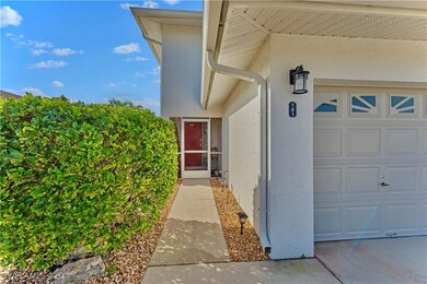 Property entrance with an attached garage and stuc