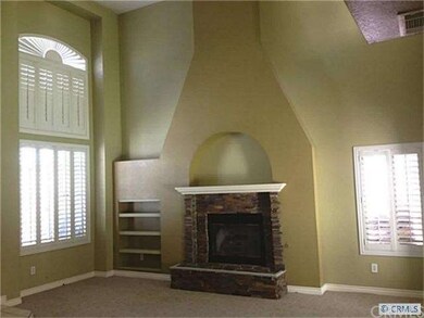 Dramatic fireplace and 2 story ceilings in living 