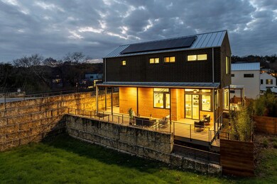 Back of house featuring metal roof, fence private