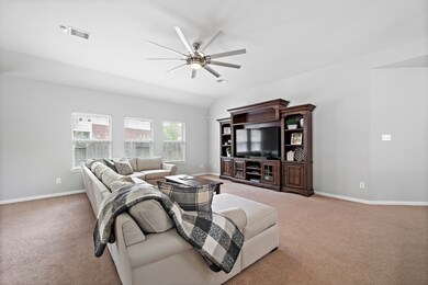 Living room is large for entertainment.  Windows add light to brighten the room.  Neutral paint.