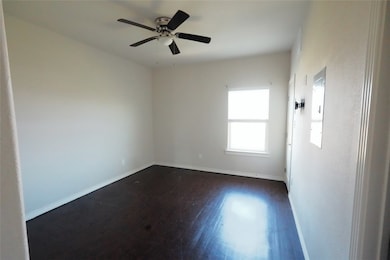 Unfurnished room with dark wood-style flooring, ce