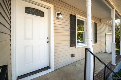 View of exterior entry with covered porch