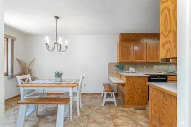 Dining room featuring a chandelier and light stone finish flooring