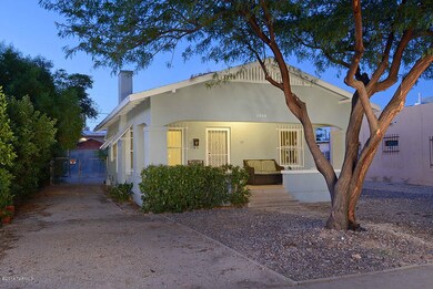 large front porch canopied by trees