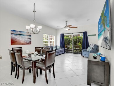 Dining space with ceiling fan with notable chandelier and light tile patterned flooring