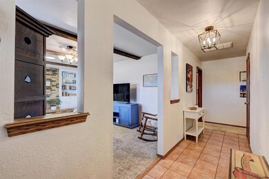 Hallway with light tile patterned floors, baseboar